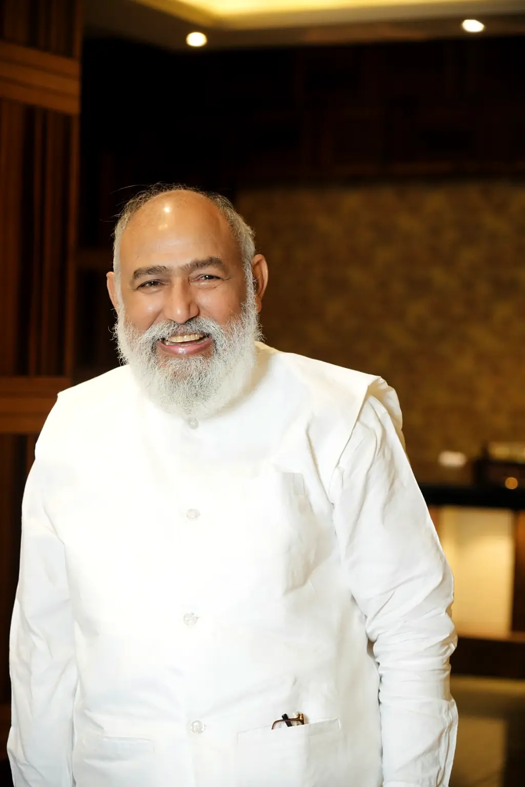 Pujya Guruji smiling in white