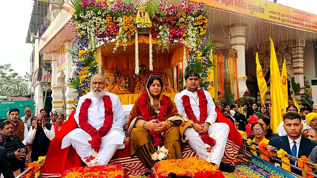 Guruji, Guru Maa and Swami ji on the flower chariot