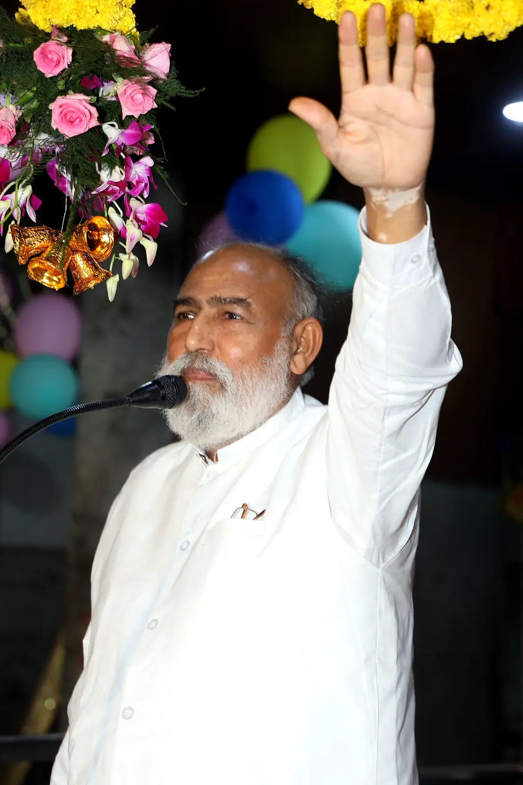 Guruji raising his hand in blessing