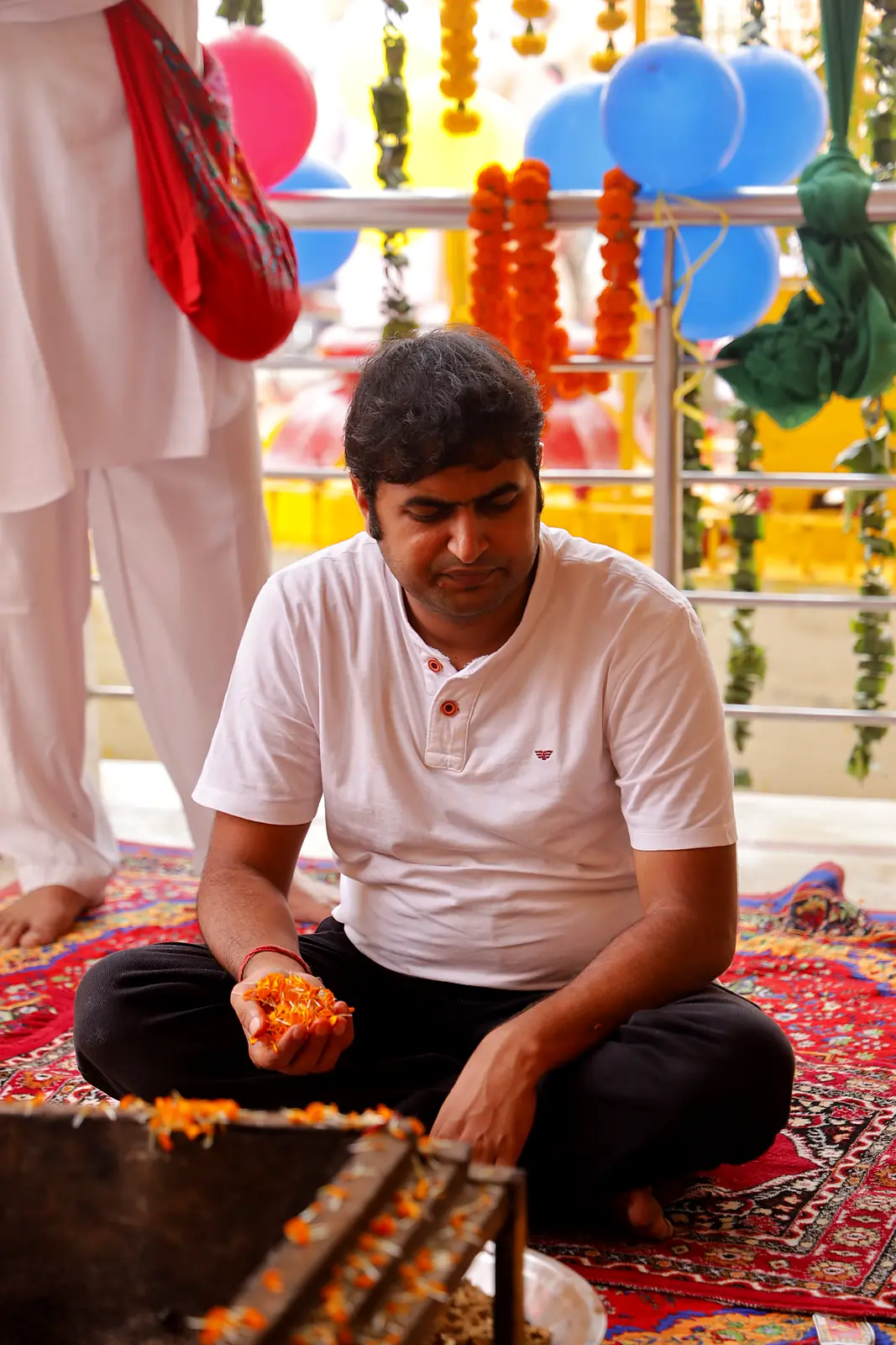 Devotee offering flowers into the havan