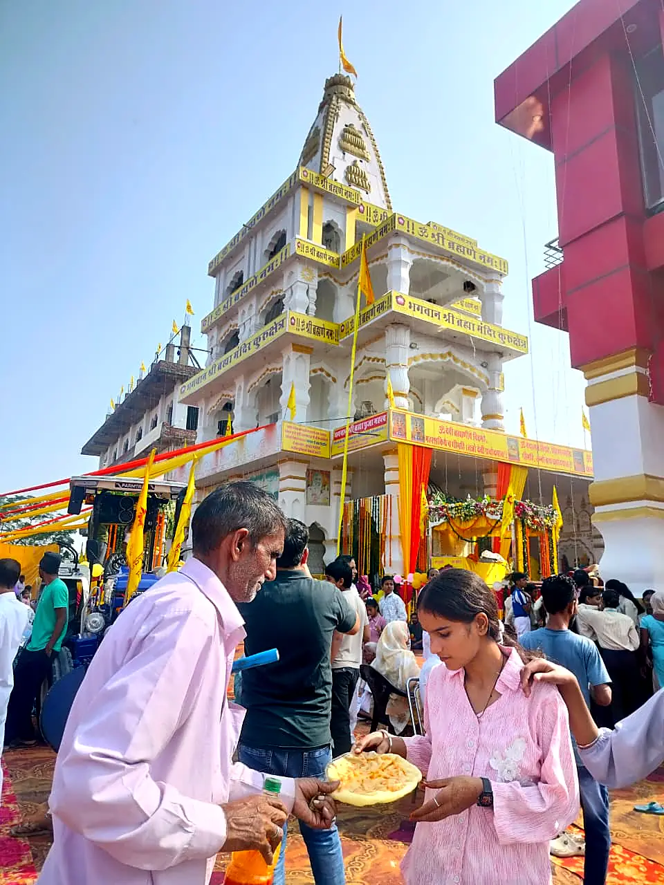 Devotees receiving prasad outside the mandir
