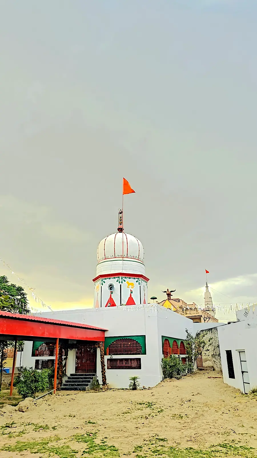 White shikhara and saffron dhwaja of the mandir